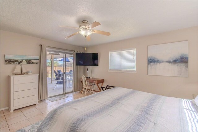 122 Palm Dr, Rockport, TX 78382 - bedroom with tile patterned flooring, a textured ceiling, ceiling fan, and access to outside