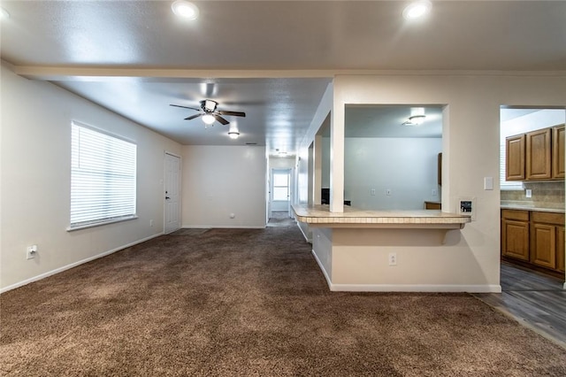 5921 Riley Dr, Corpus Christi, TX 78412 - unfurnished living room featuring dark carpet, a ceiling fan, healthy amount of natural light, and recessed lighting