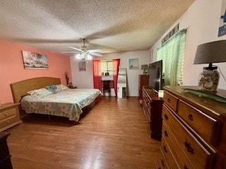 1638 W Palm Dr, Aransas Pass, TX 78336 - bedroom with a textured ceiling, wood finished floors, and multiple windows