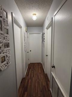 1638 W Palm Dr, Aransas Pass, TX 78336 - hallway with a textured ceiling and dark wood-style floors
