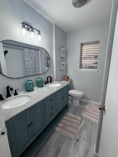 1638 W Palm Dr, Aransas Pass, TX 78336 - bathroom with double vanity and wood finished floors