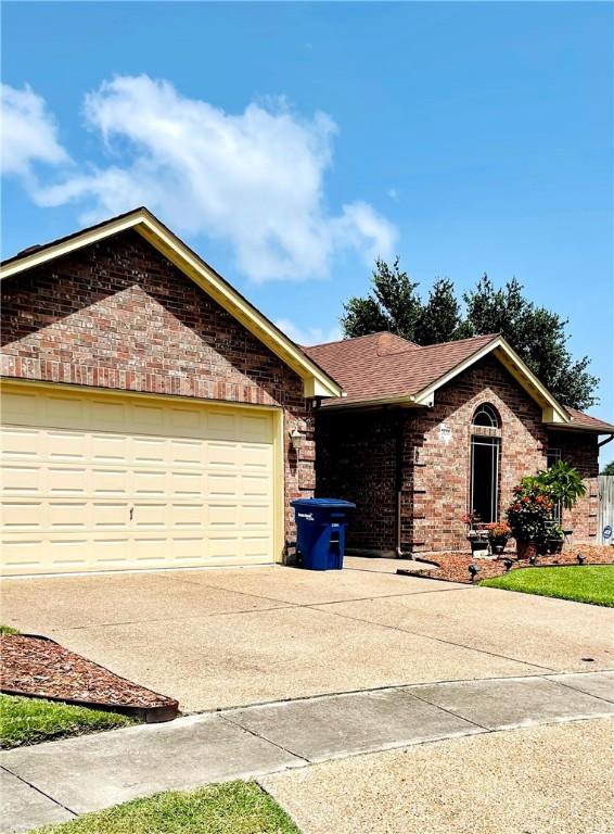 ranch-style home featuring a garage