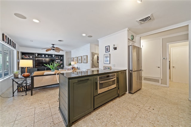 kitchen with stainless steel appliances, dark stone counters, kitchen peninsula, ceiling fan, and crown molding