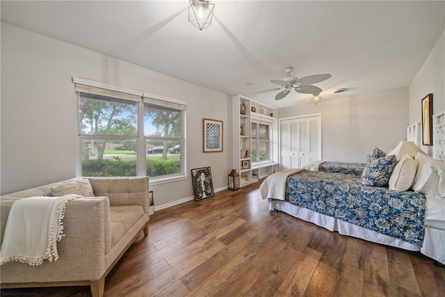 bedroom with a closet, hardwood / wood-style floors, and ceiling fan