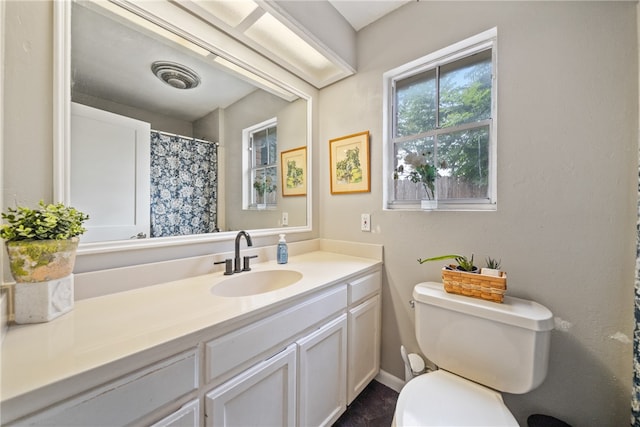 bathroom featuring toilet and vanity