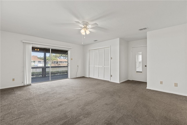 carpeted spare room featuring ceiling fan