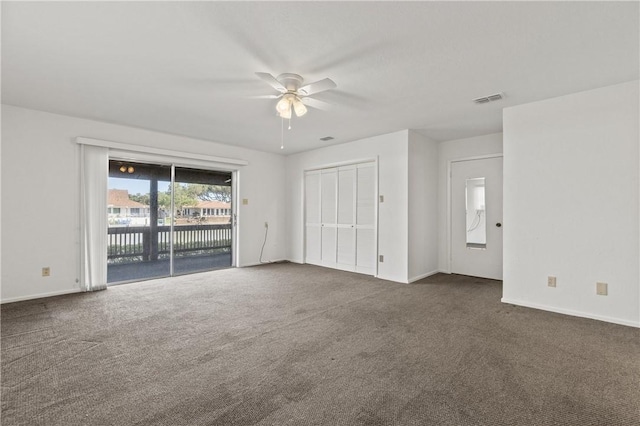 unfurnished bedroom with access to outside, dark carpet, baseboards, and ceiling fan