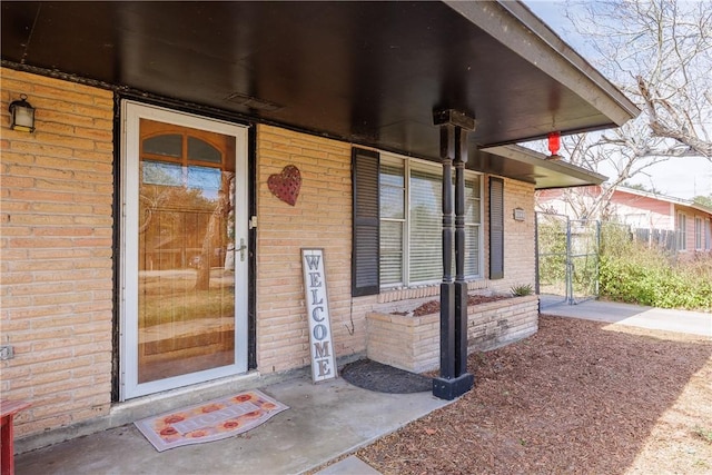 property entrance featuring brick siding