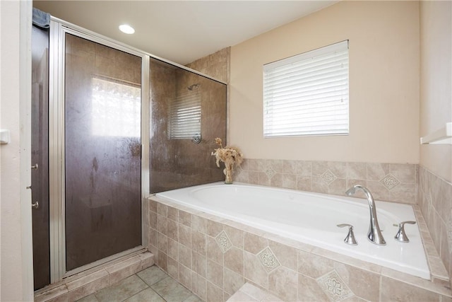 full bathroom with a garden tub, tile patterned flooring, and a shower stall