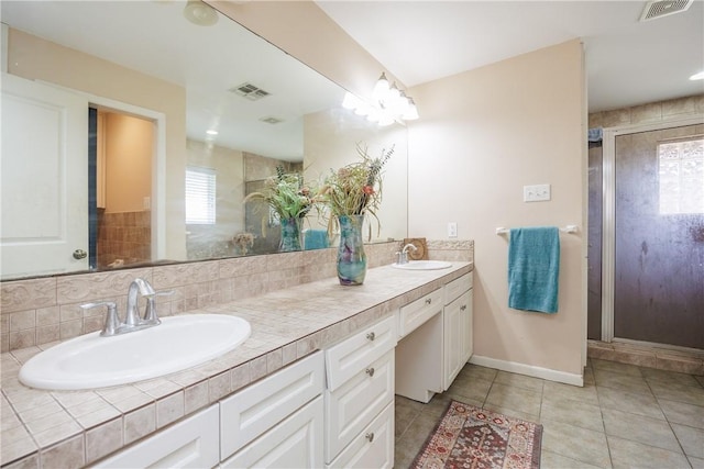 bathroom with double vanity, tile patterned flooring, a sink, and visible vents