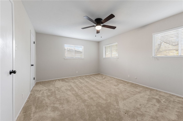 unfurnished room featuring ceiling fan and light colored carpet