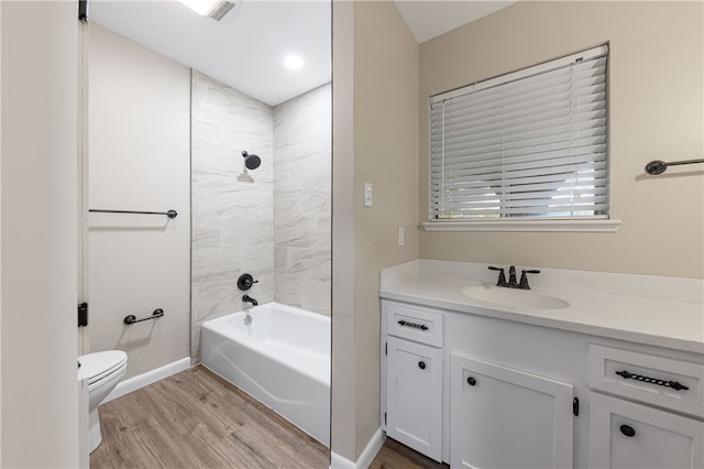 full bathroom with hardwood / wood-style floors, vanity, toilet, and shower / bathtub combination