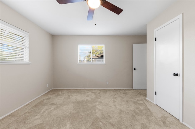 carpeted empty room with ceiling fan