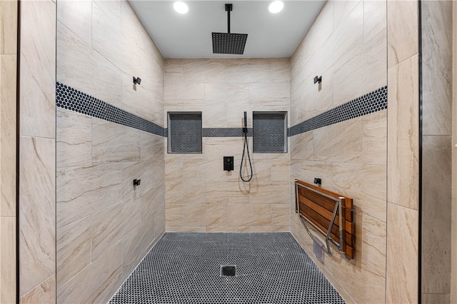 bathroom featuring tile walls and tiled shower