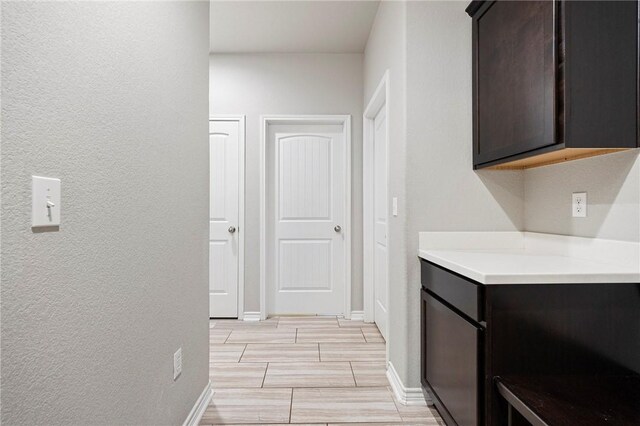 1012 Santa Catalina St, Portland, TX 78374 - hallway featuring wood tiled floors, baseboards, and a textured wall