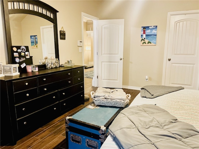 bedroom with dark hardwood / wood-style floors