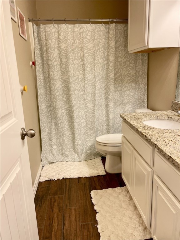 bathroom featuring hardwood / wood-style floors, toilet, and vanity