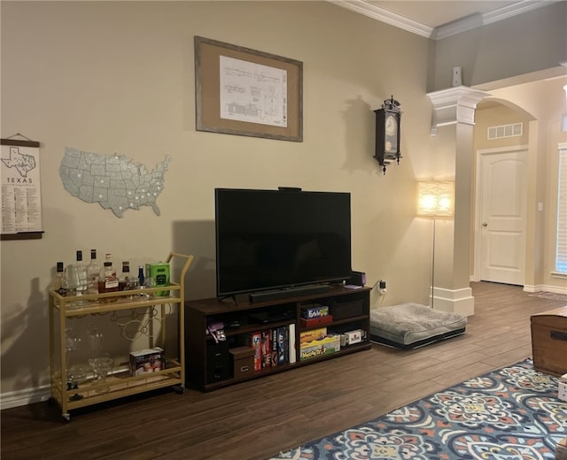 living room featuring hardwood / wood-style floors, decorative columns, and ornamental molding