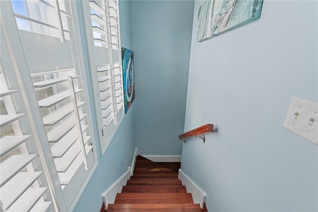 stairs with wood finished floors and baseboards