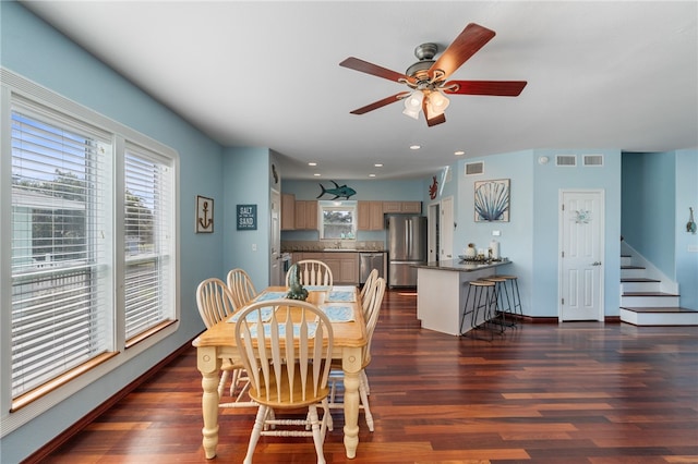 dining space featuring dark wood-type flooring, sink, and ceiling fan