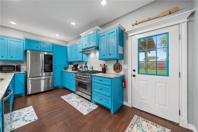 230 Valerie St, Corpus Christi, TX 78418 - kitchen featuring appliances with stainless steel finishes, blue cabinetry, under cabinet range hood, light stone counters, and recessed lighting