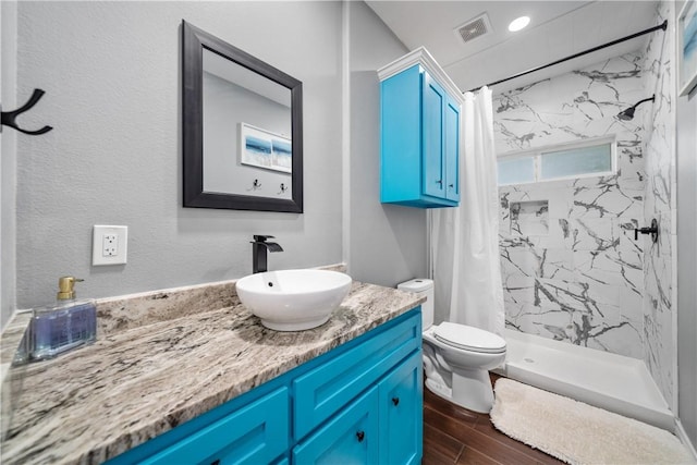 230 Valerie St, Corpus Christi, TX 78418 - bathroom with wood finished floors, a stall shower, vanity, and toilet