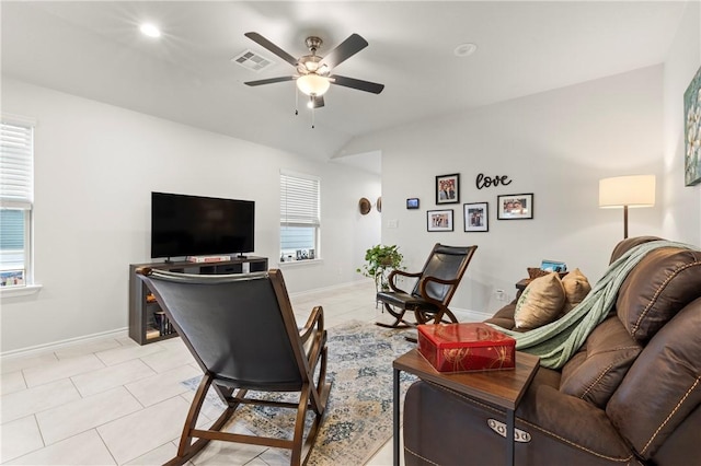 tiled living room featuring ceiling fan