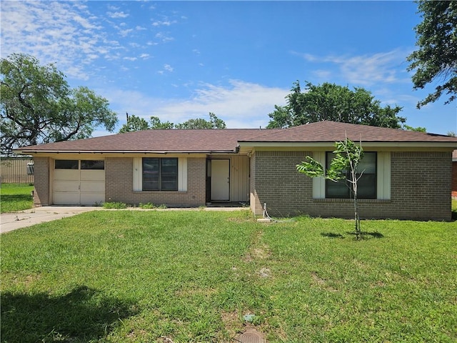 909 Johnson St, Woodsboro, TX 78393 - single story home with brick siding, a garage, concrete driveway, and a front lawn