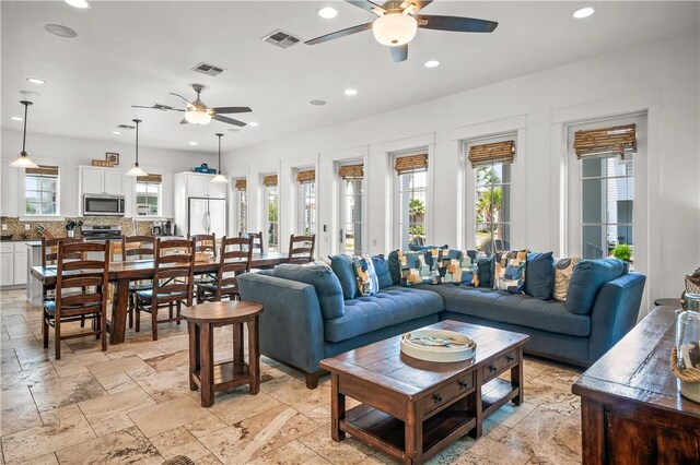 104 Still Water Dr, Port Aransas, TX 78373 - living area with ceiling fan, recessed lighting, healthy amount of natural light, and stone tile floors