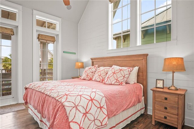 104 Still Water Dr, Port Aransas, TX 78373 - bedroom featuring multiple windows, access to exterior, wood finished floors, and high vaulted ceiling