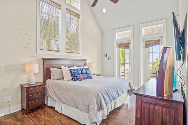 bedroom featuring dark hardwood / wood-style floors, ceiling fan, and lofted ceiling