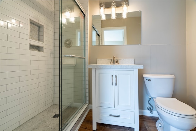 bathroom featuring walk in shower, vanity, and toilet