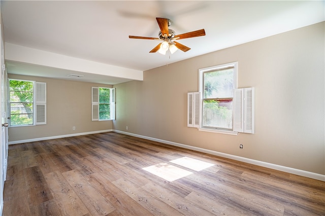 empty room featuring hardwood / wood-style flooring and ceiling fan