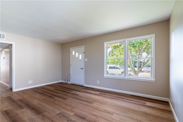 spare room with wood-type flooring