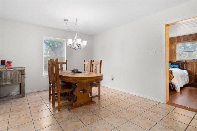 tiled dining area featuring an inviting chandelier