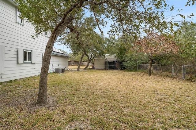 view of yard featuring central AC and a shed