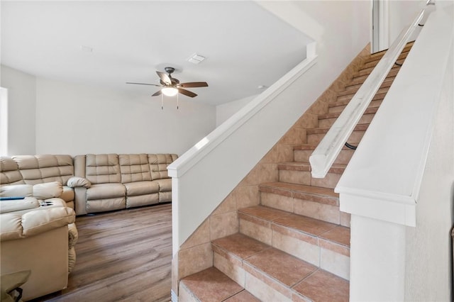 stairs with ceiling fan and wood-type flooring