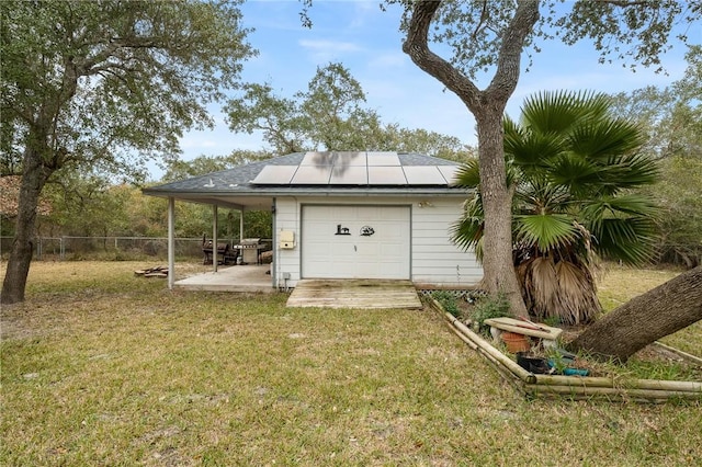 view of outbuilding featuring a lawn and solar panels