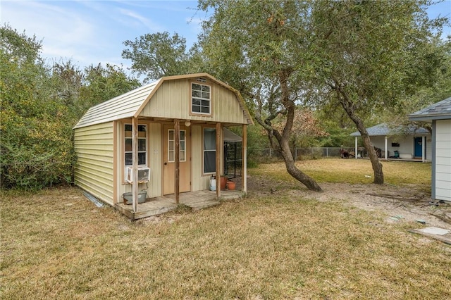 view of outbuilding with cooling unit and a yard