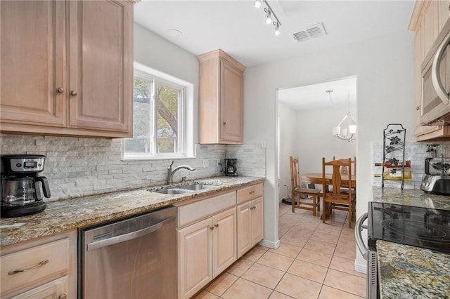 kitchen featuring sink, light tile patterned floors, appliances with stainless steel finishes, light stone counters, and light brown cabinets