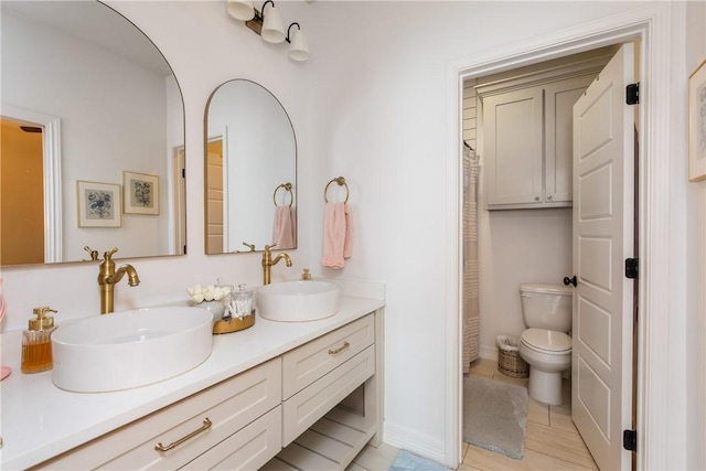 14933 Lake Mead, Robstown, TX 78380 - full bathroom with toilet, double vanity, and tile patterned floors