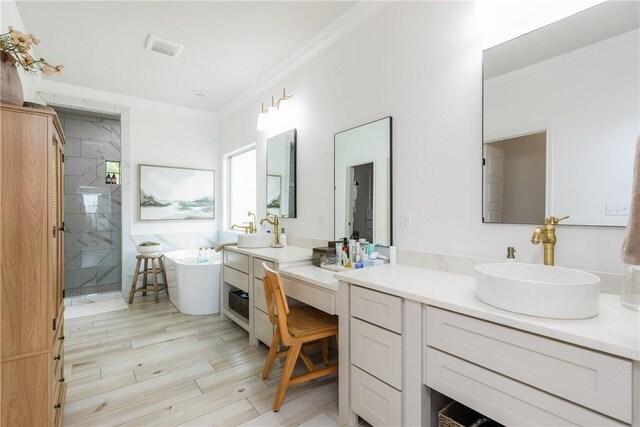 14933 Lake Mead, Robstown, TX 78380 - full bath with a stall shower, crown molding, a freestanding bath, wood finished floors, and two vanities