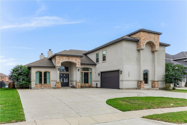 14933 Lake Mead, Robstown, TX 78380 - french country style house featuring driveway, stucco siding, a garage, roof with shingles, and a front lawn