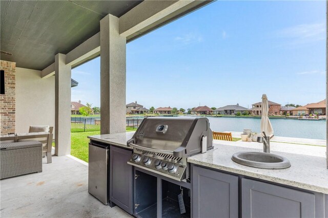 14933 Lake Mead, Robstown, TX 78380 - view of patio with area for grilling, fence, a grill, a residential view, and a water view