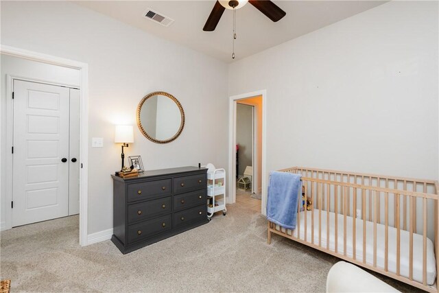 14933 Lake Mead, Robstown, TX 78380 - carpeted bedroom with baseboards, a crib, and a ceiling fan