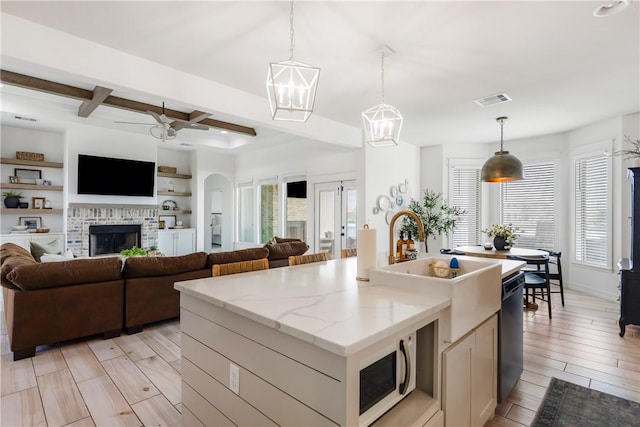 14933 Lake Mead, Robstown, TX 78380 - kitchen featuring open floor plan, dishwashing machine, healthy amount of natural light, a ceiling fan, and beam ceiling