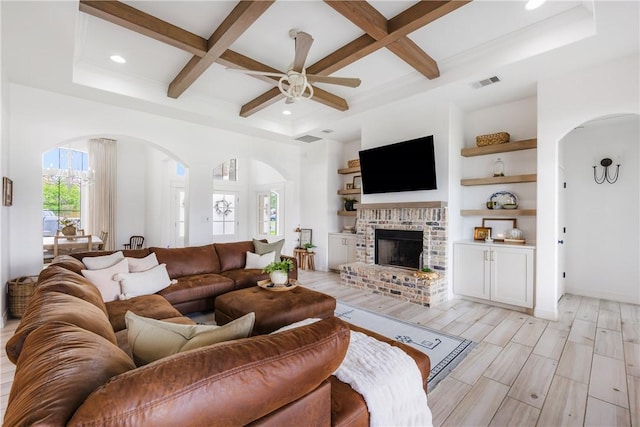 14933 Lake Mead, Robstown, TX 78380 - living area with arched walkways, coffered ceiling, a ceiling fan, beam ceiling, and a fireplace