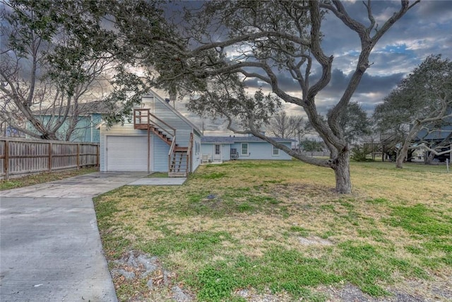 4034 Laguna Shores Rd, Corpus Christi, TX 78418 - view of front of home featuring a garage, fence, concrete driveway, stairway, and a front lawn