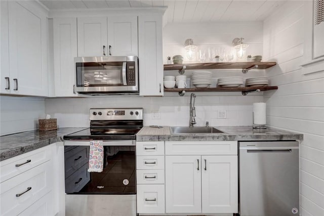 4034 Laguna Shores Rd, Corpus Christi, TX 78418 - kitchen with appliances with stainless steel finishes, white cabinetry, a sink, and open shelves