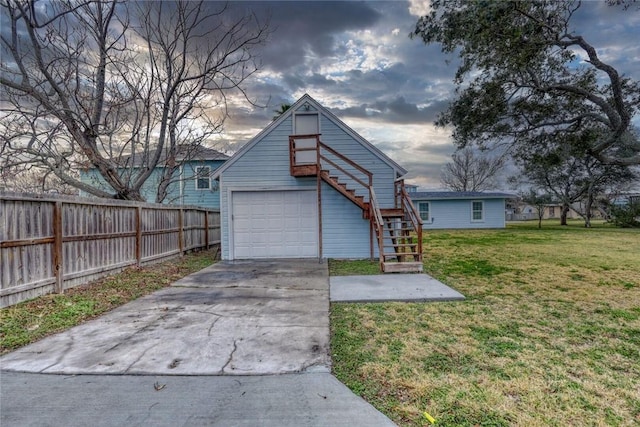 4034 Laguna Shores Rd, Corpus Christi, TX 78418 - view of front of house with concrete driveway, a front lawn, stairway, and fence